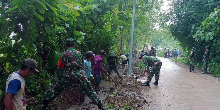 Antisipasi Banjir, Koramil 0812/11 Kedungpring dan Warga Bersihkan Saluran Irigasi Jalan Desa